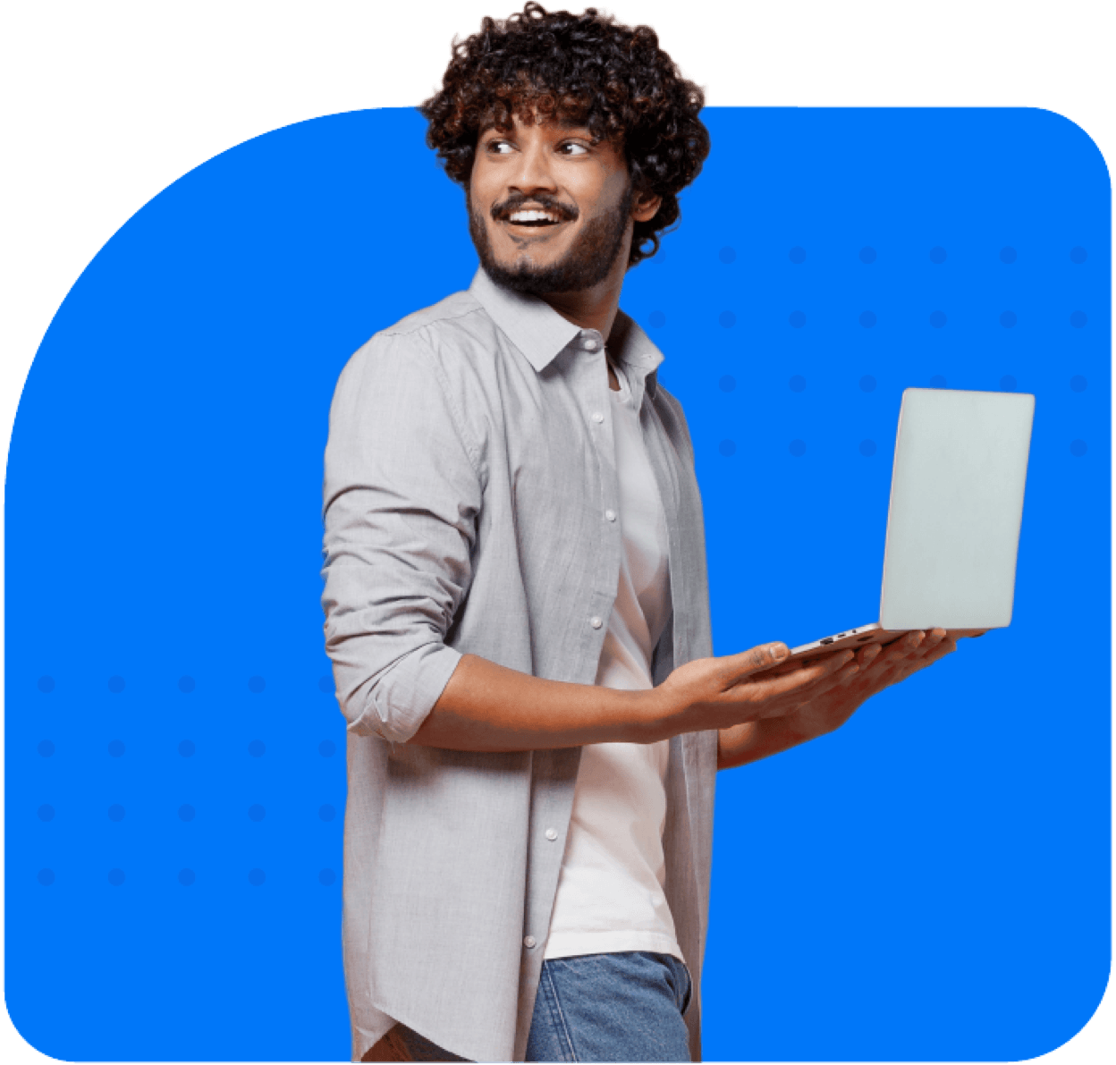 Smiling man standing up with laptop in his hands, turning his head behind with a surprised expression