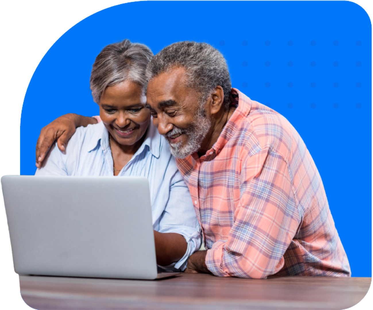 Smiling senior couple looking down at laptop